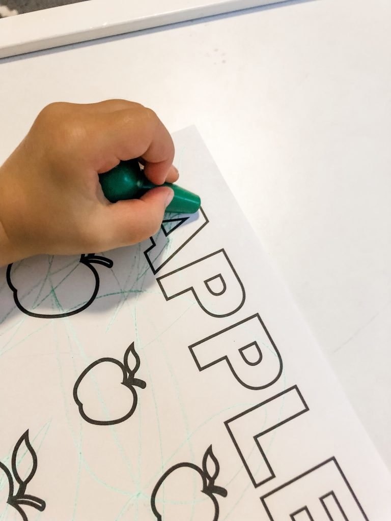 A fall apple activity with FREE PRINTABLES for your toddler to develop fine motor skills using stickers, crayons, or dot markers. Help them to learn colors & counting as well during this activity.