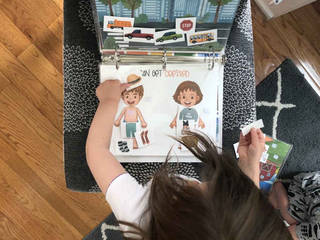 Make a busy binder for your toddler or preschooler to help them learn new concepts. DIY the quiet book for your child with velcro and a binder.