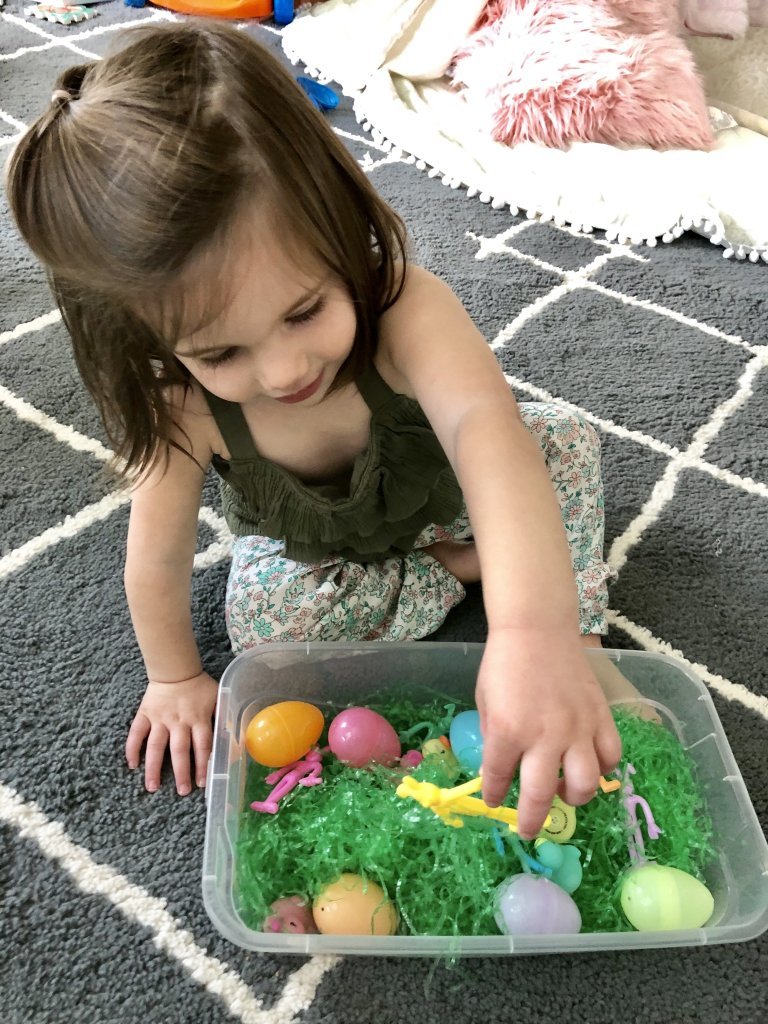 Try this simple Easter egg sensory bin activity with your baby or toddler. Easy to set up & use household items. Improve fine motor skills & language