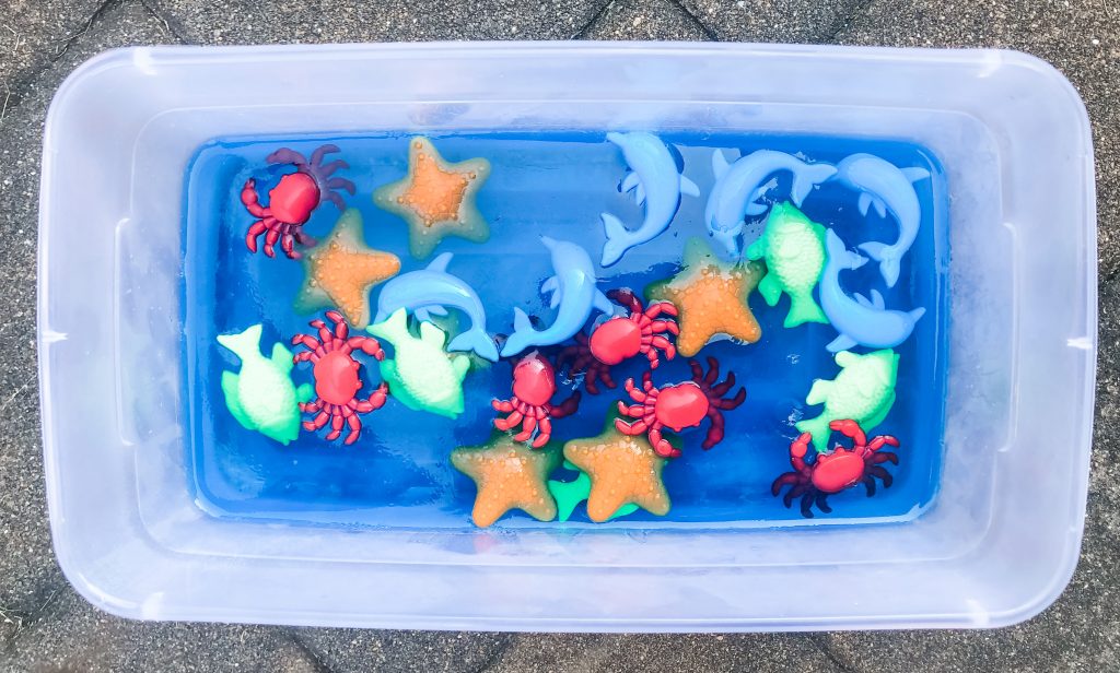 This ocean scene jell-o dig sensory bin activity is great for babies, toddlers, or even preschoolers to explore and learn through play outside in the summer