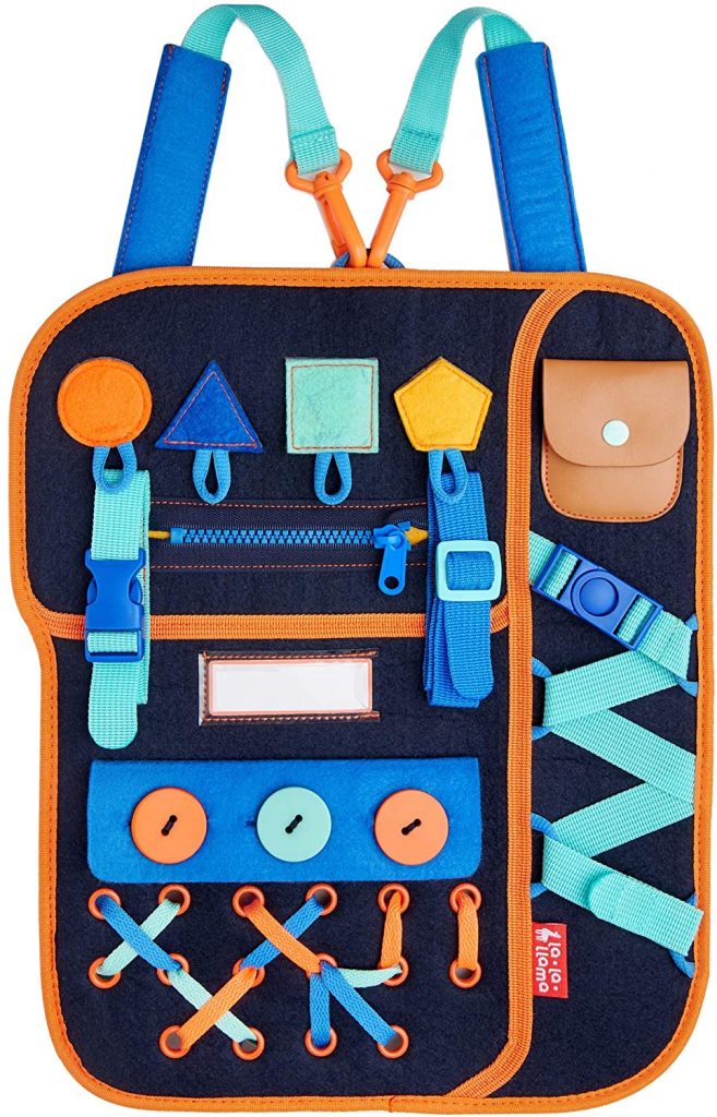 This is another take on the dressing busy board from La-la-llama. It is a great example of a soft busy board that packs 12 activities to help your little ones learn how to get dressed. Made of premium wool material, this toddler busy board is lightweight yet sturdy. Designed to withstand the stress of normal play, the board and the fastenings on it are soft yet sturdy. As well as having detachable carry straps, the activity board can be folded for easy carrying.