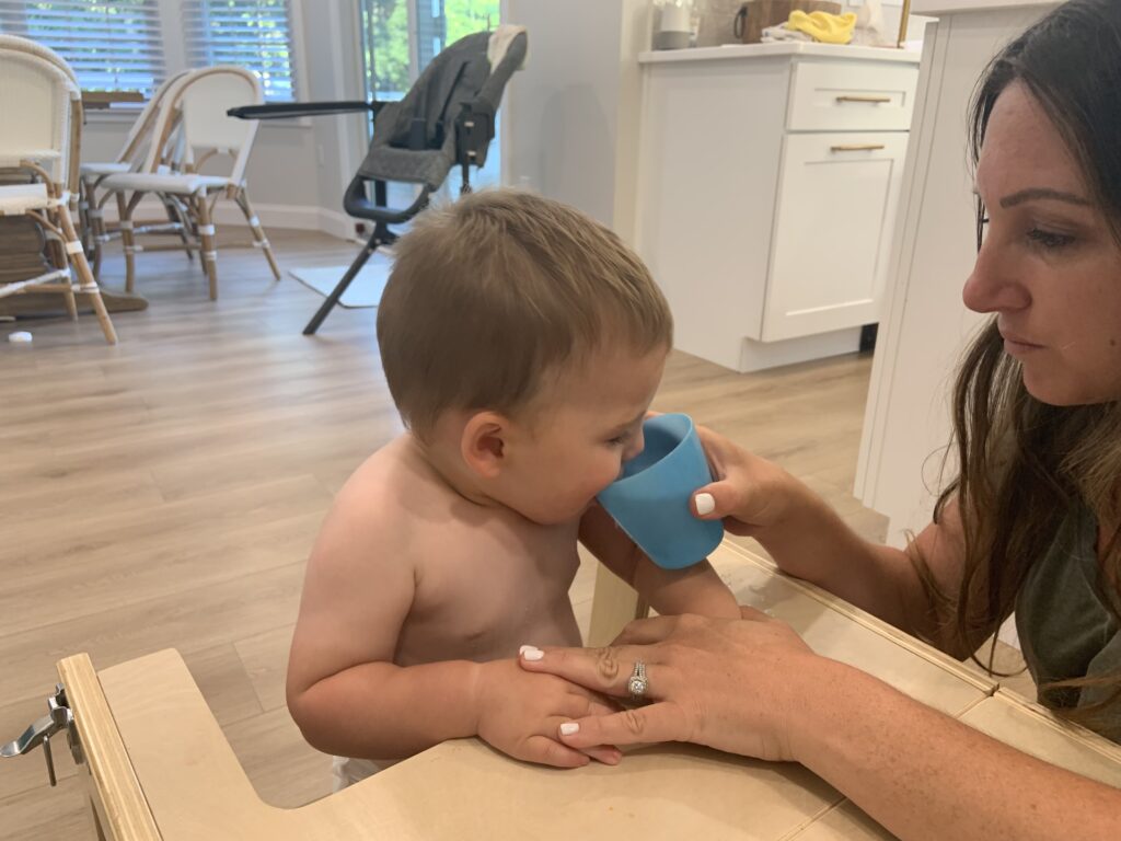Your baby can drink from an open cup by 6 months old! Here are some tips on how to start them and why it's so beneficial